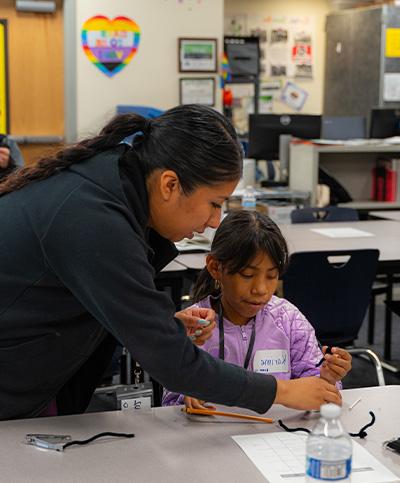 teacher helping student with school project